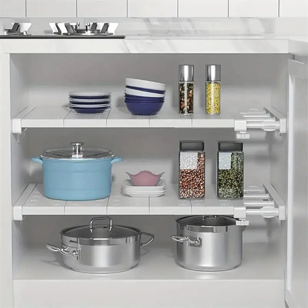 Kitchen cabinet with pots, pans, and spices on shelves divided using shelf divider.